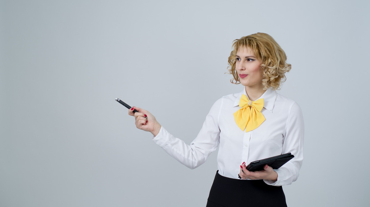 Business woman pointing with pen