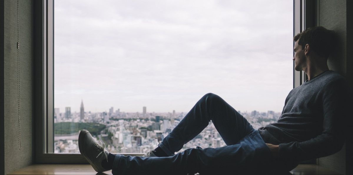 man sitting down looking over the city