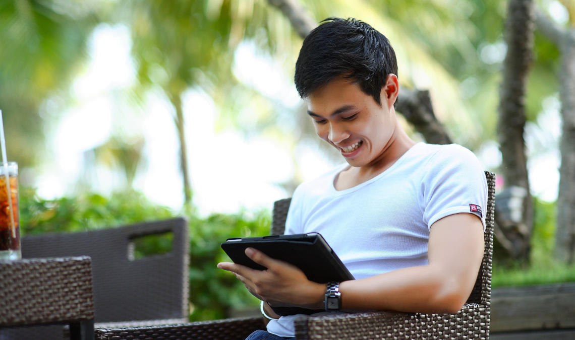 man looking at a tablet