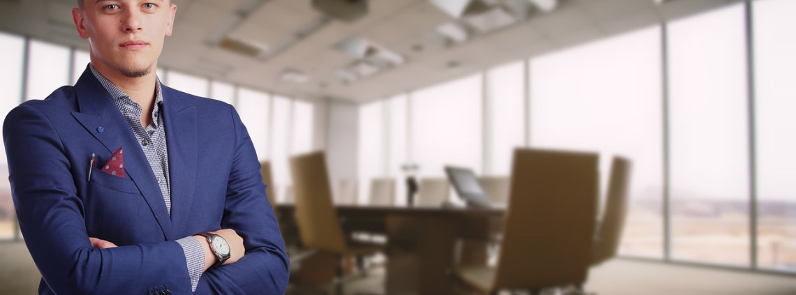 well dressed man in conference room